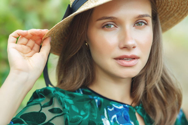 Beautiful woman in nature. Young girl in a hat.  - Фото, зображення