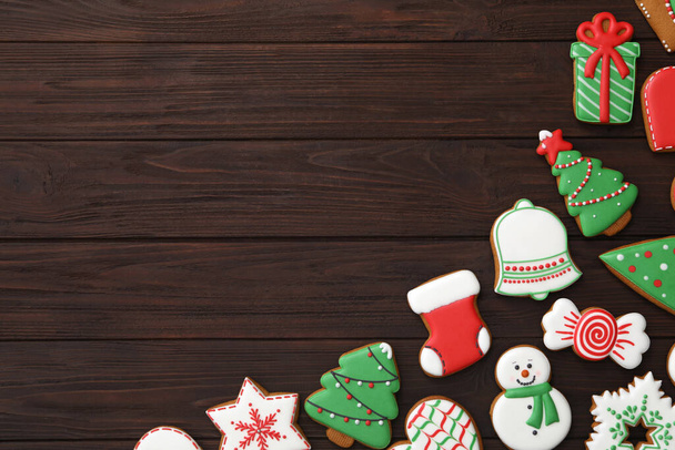 Many different delicious Christmas cookies on wooden table, flat lay. Space for text - Fotó, kép