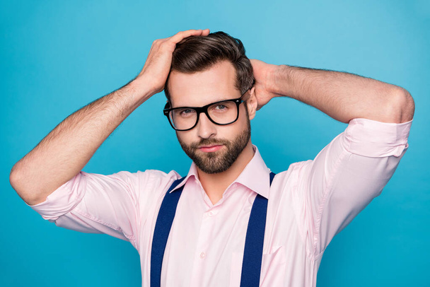 Closeup photo of handsome business man trend clothes hold arms head checking neat hairdo after salon styling wear specs pink shirt suspenders isolated blue color background - Fotografie, Obrázek