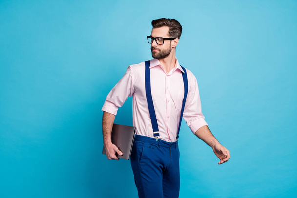 Profile photo of handsome confident business man guy hold computer walk meeting office successful boss chief worker wear specs shirt suspenders pants isolated blue color background - Фото, зображення