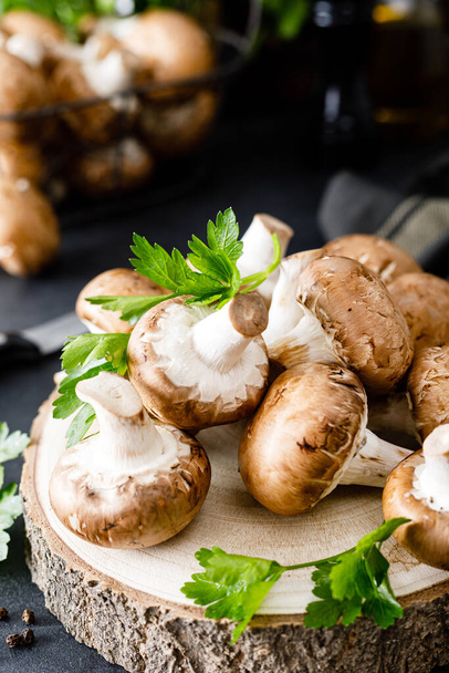 Raw mushrooms champignons on black background, cooking fresh champignon - Zdjęcie, obraz
