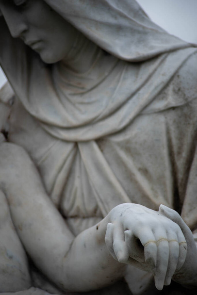 Stone cemetery statue, Mary holding Jesuss hand. - Photo, Image