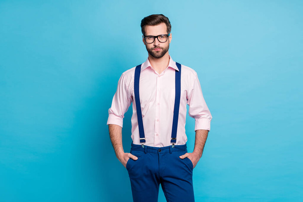 Photo of handsome macho business man cool trend clothes guy smile without teeth eyesight care vision specs wear pink shirt suspenders pants isolated pastel blue color background - Zdjęcie, obraz