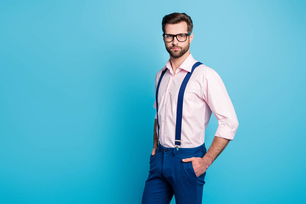 Profile photo of handsome macho business man cool trend clothes guy smile without teeth eyesight care vision specs wear pink shirt suspenders pants isolated blue color background - Foto, afbeelding