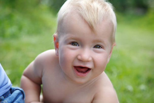 Portrait of a happy smiling baby on a warm summer day outdoor. - Zdjęcie, obraz