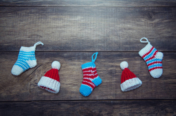Christmas socks on old wooden background. - Foto, afbeelding