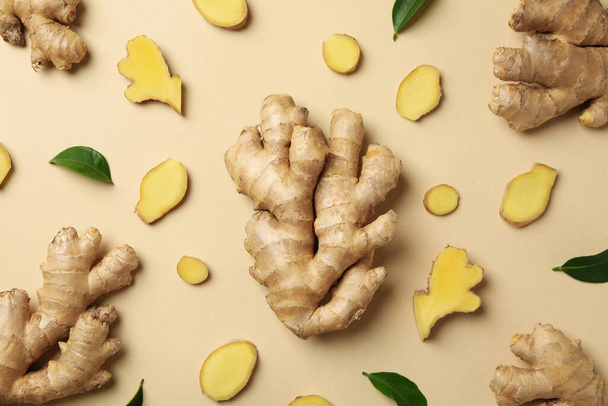 Fresh ginger and leaves on beige background, top view - 写真・画像