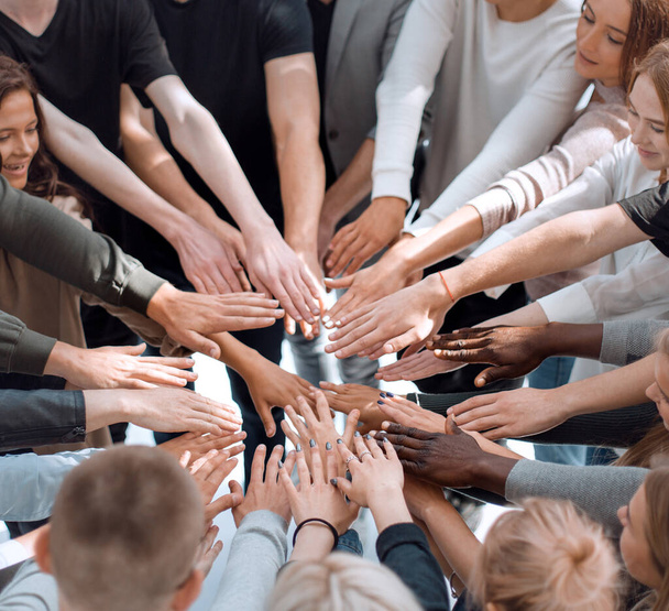 group of diverse people joining their hands in a circle. - Foto, Imagem