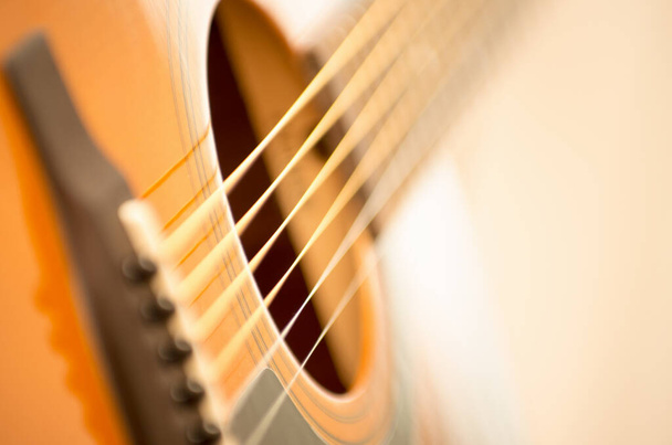 Acoustic guitar with very shallow depth of field - Photo, Image