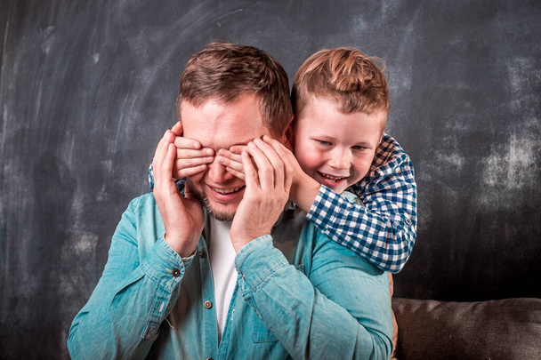 Father's day. Happy little kid boy hugging dad while close eyes. Father and son. Child is making surprise. - Valokuva, kuva