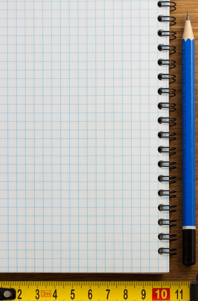checked notebook on wood - Foto, imagen
