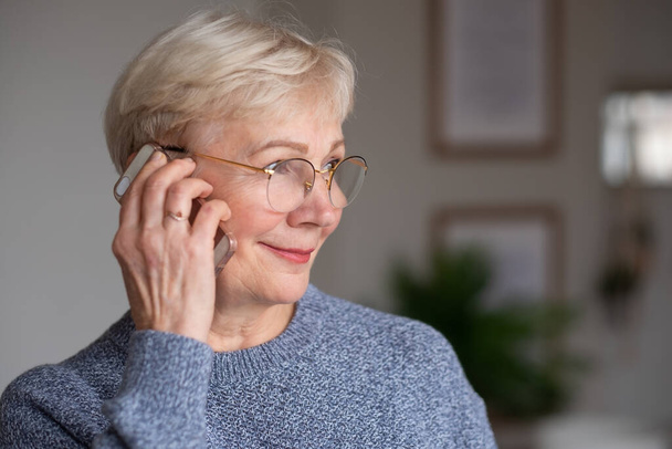 Caucasian woman calling to her family at home. - Photo, Image
