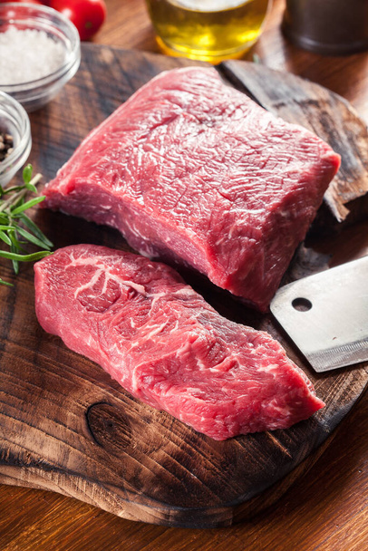 Raw beef steak on a cutting board. Making steak for grilling - Fotografie, Obrázek