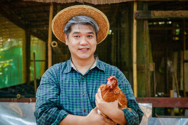 Ασιάτες αγρότες εκτρέφουν κοτόπουλα για να κάνουν αυγά σε μικρές οικογενειακές επιχειρήσεις. - Φωτογραφία, εικόνα