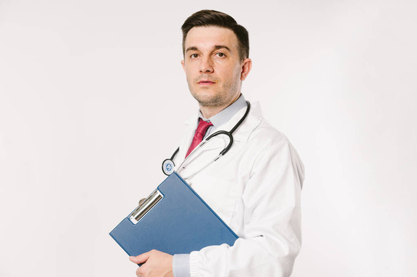 Young man doctor in uniform  posing in studio - Fotografie, Obrázek