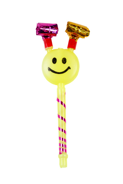 Yellow toy whistle with a smiley face isolated - Foto, afbeelding