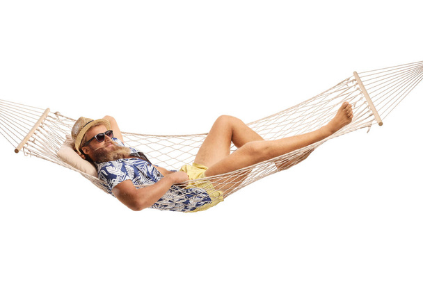 Bearded guy laying in a hammock swing isolated on white background - Fotografie, Obrázek
