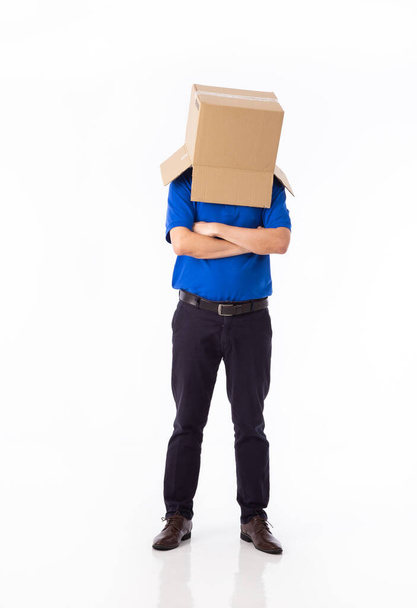 man in a bluer T-shirt with a cardboard box on his head makes a gesture with his hands isolated on white background - Foto, immagini