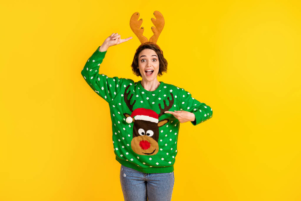 Shocked surprised crazy girl impressed x-mas christmas time celebration costume point finger antlers reindeer decor pullover headband isolated bright shine color background - 写真・画像