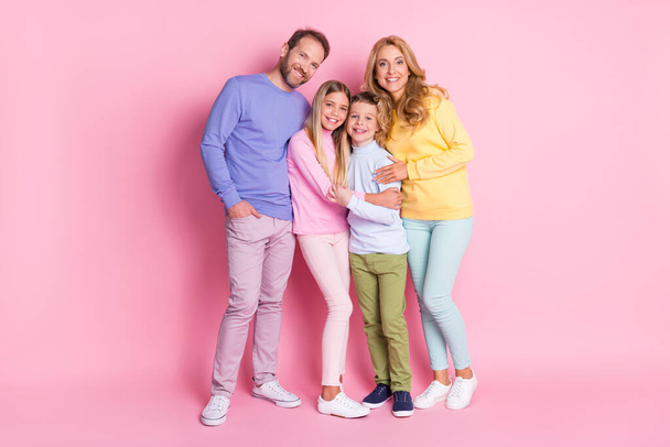 Full size photo of positive family dad hug mom and two kids boy girl isolated over pink color background - Φωτογραφία, εικόνα