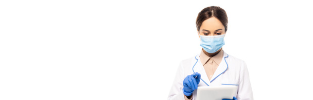 Horizontal image of doctor in medical mask and latex gloves using digital tablet isolated on white - Photo, Image