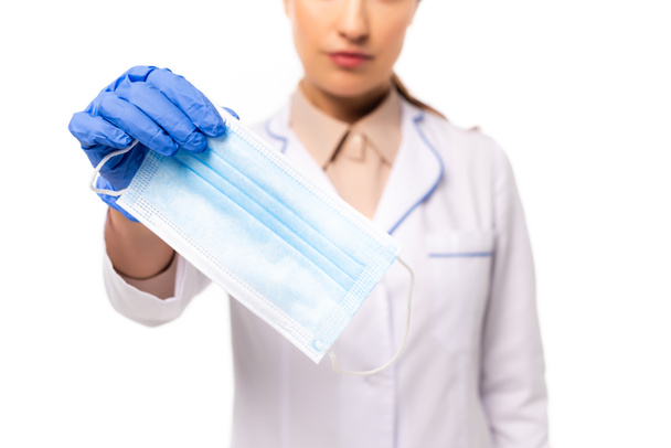 Cropped view of doctor in latex glove showing medical mask isolated on white - Fotoğraf, Görsel