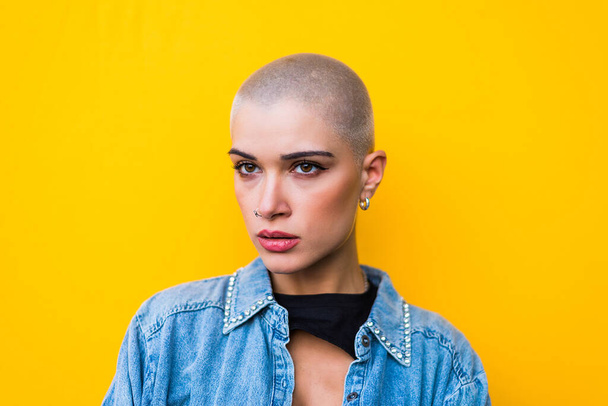 Pretty girl with stylish clothes posing - Beautiful woman with shaved head portrait - Photo, image