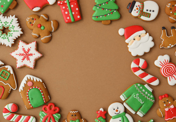 Frame made with different Christmas gingerbread cookies on brown background, flat lay. Space for text - Фото, зображення