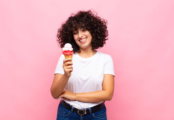 young woman with an ice cream smiling with a happy, confident expression with hand on chin, wondering and looking to the side - Foto, immagini