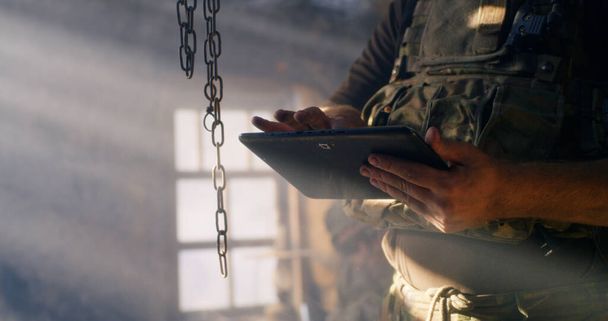 Crop soldiers browsing data on tablet - Foto, Imagem