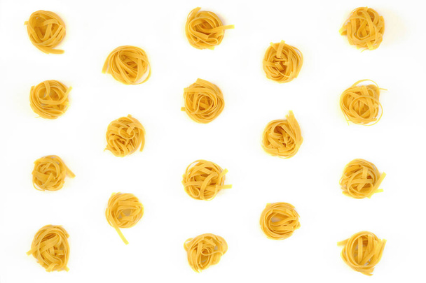 Image of a group of raw noodles placed on a white cardboard background and captured from above - Фото, зображення