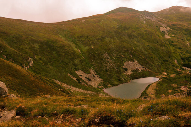 Озеро Бребенескул в хмарах, вид озера з чорногорського хребта, високогірне екологічно чисте озеро в Карпатах, природний заповідник. - Фото, зображення