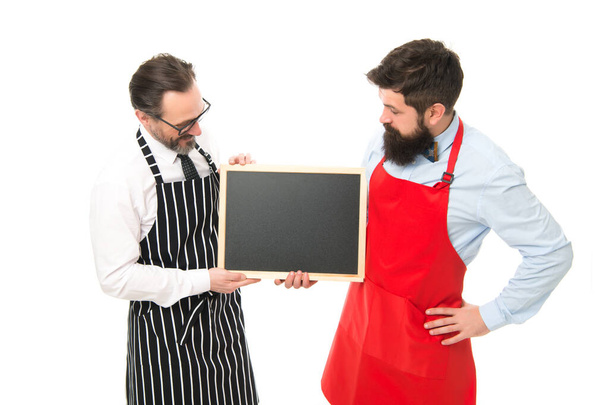 cafe and restaurant opening. catering business. welcome on board. partners start up. menu planning. happy chef team in apron. bearded men with blackboard, copy space. restaurant opening advertisement - Foto, Imagem