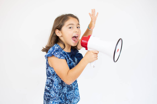 Little girl screaming and shouting with megaphone. - Foto, imagen