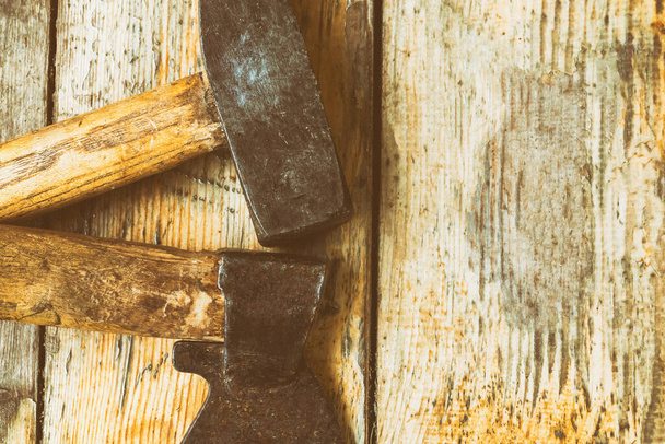 hammer and ax a pair of tools with copy space on wooden planks background - Foto, Imagen
