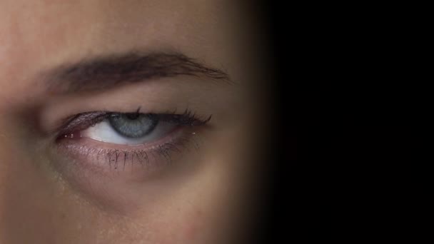 Vereinzelte Nahaufnahme des Augen-Porträts einer jungen Dame auf schwarzem Hintergrund - Filmmaterial, Video
