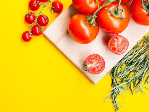 Healthy and dieting concept. Cherry tomatoes with rosemary isolated on yellow color studio background with copy space. Flat lay, View from above, from top - Foto, Imagen