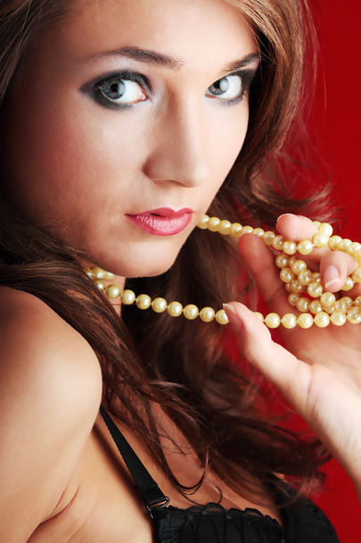 Sexy young woman with a pearls - Φωτογραφία, εικόνα