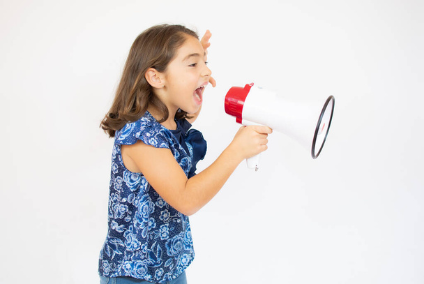 Little girl screaming and shouting with megaphone. - Φωτογραφία, εικόνα