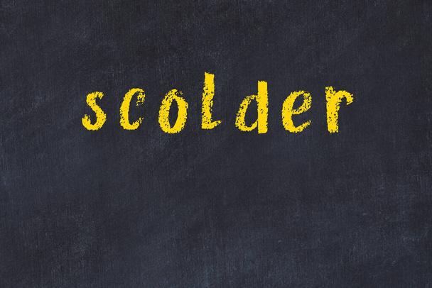 College chalk desk with the word scolder written on in - 写真・画像