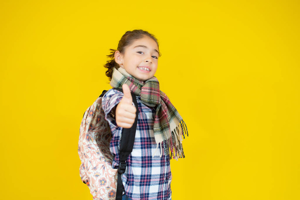 funny child school girl on a yellow background - Фото, изображение