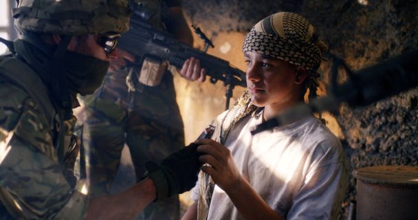 Savaşta genç terörist, asker yakınlarında. - Fotoğraf, Görsel