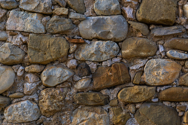 Texture of an old wall from different stones - Photo, image