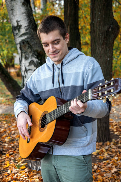 guy plays guitar in park - Photo, Image