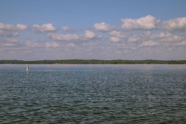 風の強い日には青い空と雲が広がる湖の景色 - 写真・画像