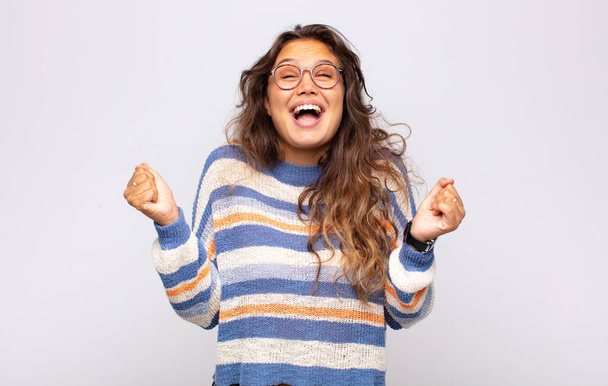 Woman looking extremely happy and surprised, celebrating success, shouting and jumping - Foto, immagini