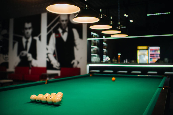 Billiard table with green surface and balls in the billiard club - 写真・画像