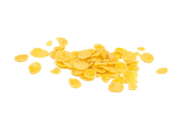 Golden yellow crunchy corn flakes cereal heap isolated on white background. - Photo, Image