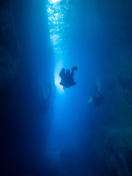 Divers in the canyon at the Inland Sea on the island of Gozo, Malta - Photo, Image