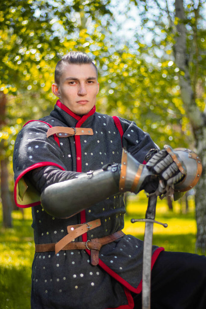 Portrait of a medieval nomadic warrior in armor against the background of a summer forest. - Foto, afbeelding
